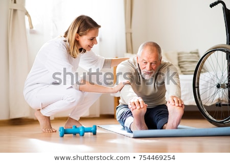 Zdjęcia stock: Nurse Helping Senior Man With Dumbbell Exercise