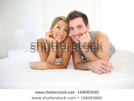 Stock fotó: Man And Woman Smiling Laid In A Bed