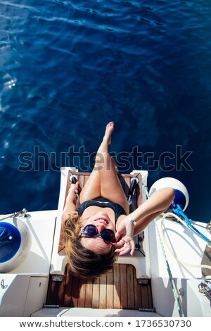 Stock fotó: Pretty Young Woman Relaxing On The Yacht On Sea At Sunny Day