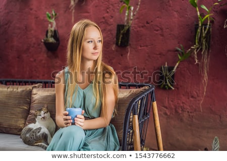 Сток-фото: Young Woman Having A Mediterranean Breakfast Seated At Sofa And Drinks Trendy Drink Blue Latte Hot