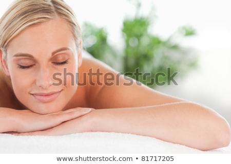 Foto stock: Woman Smiles And Relaxes On Massage Table