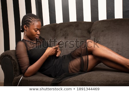 Stock photo: Woman Texting On Her Handy Laying