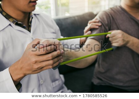 ストックフォト: Close Up Of A A Man Stretching An Elbow In A Room