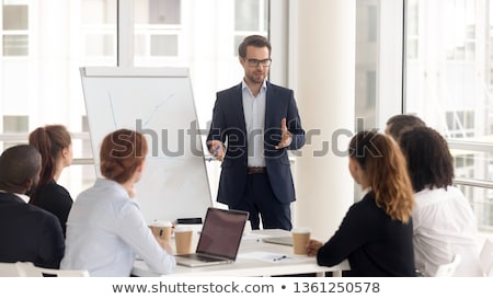 Foto stock: Manager Giving Presentation At Office To Colleagues