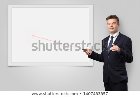 Foto stock: Businessman With Laser Pointer And Copyspace White Blackboard