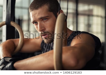 [[stock_photo]]: Crossfit Dip Ring Man Relaxed After Workout At Gym