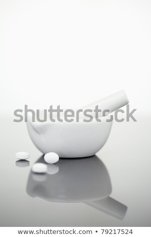 Stock fotó: Mortar And Pestle With Pills Against A White Background