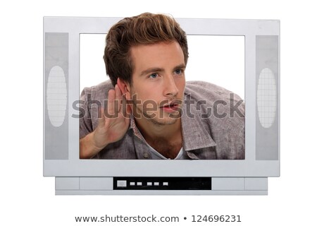 Foto stock: Young Man Through A Tv Screen Listening Something Carefully