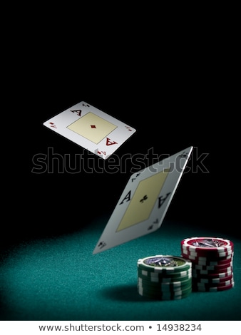 Stock photo: Fingers Holding Two Poker Chips