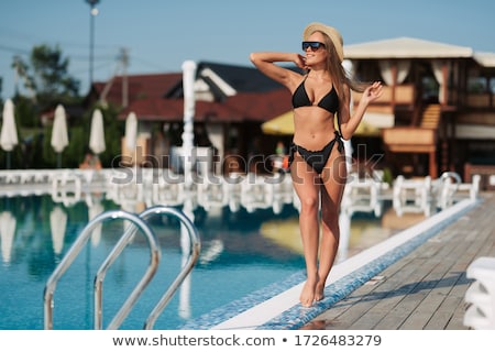 Foto stock: Tanned Beautiful Woman In Bikini And Sunglasses Sitting In Swimm