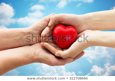 Zdjęcia stock: Close Up Of Senior And Young Woman Hands Over Sky