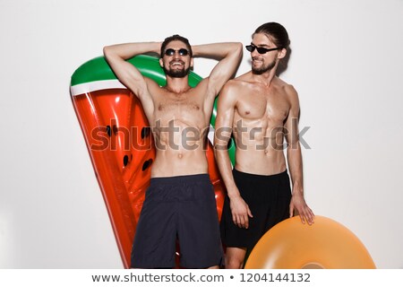 Foto d'archivio: Portrait Of A Delighted Shirtless Twin Brothers