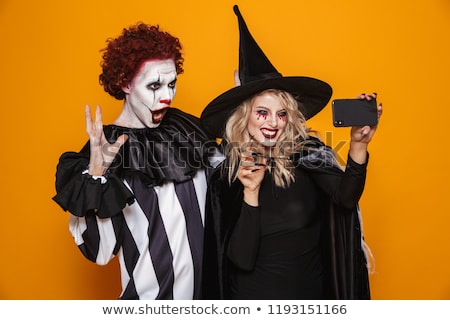 Stock photo: Cheerful Scary Witch And Clown Making Selfie Isolated