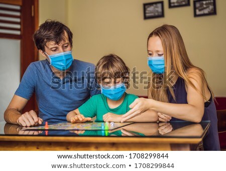 ストックフォト: Happy Family Playing Board Game At Home Stay At Home Due To Quarantine Coronovirus Infection