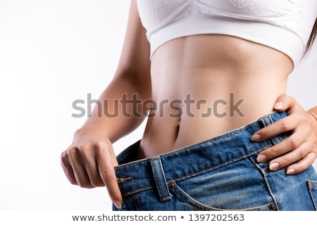 Foto stock: Woman Wearing Jeans In Too Big A Size