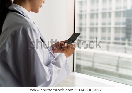 [[stock_photo]]: Young Man Standing And Typing On Her Phone With Copy Space