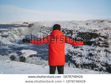 Foto d'archivio: Attractive Man Standing By Waterfalls On His Back