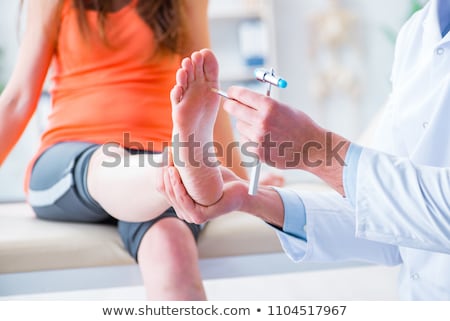 Stok fotoğraf: Doctor Checking Nerve Reflexes With Hammer