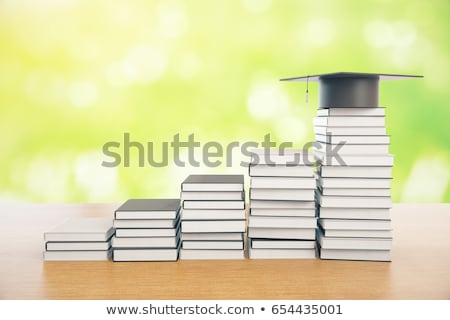 Сток-фото: Graduation Mortarboard On Top Of Stack Of Books On Abstract Back