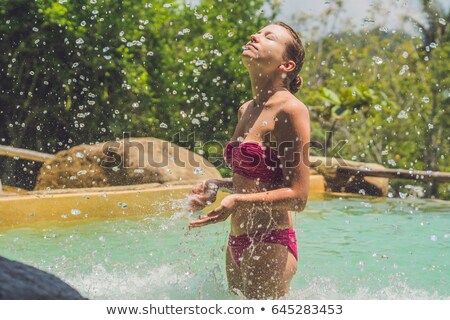 ストックフォト: Young Woman Relaxing Under A Waterfall In Aquapark