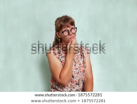 Stock fotó: Woman Thinking With Her Glasses In Her Mouth