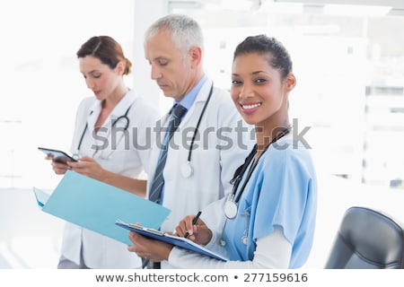 Zdjęcia stock: Portrait Of Confident Young Nurse Holding File