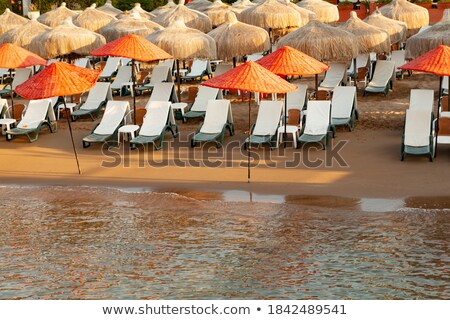 Stok fotoğraf: Sandy Beach In The Morning With Beach Beds And Umbrella