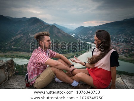 ストックフォト: Man And Woman Looking At View Of Small City With River From The