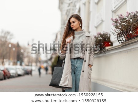 A Beautiful Young Girl In A White Coat Is Standing Near The Desk In The Office And Shaking Hands Wit Stok fotoğraf © Alones