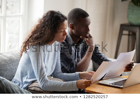 Сток-фото: Upset Couple Stressed By Bad News Receive High Taxes Looks Attentively At Papers Read Paper Lette