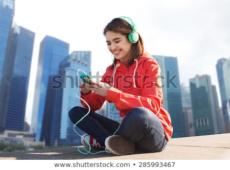 Сток-фото: Happy Woman With Earphones Over Singapore City