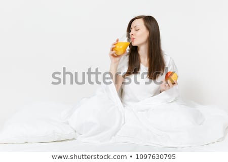 Foto d'archivio: Young Beautiful Woman With Apple In Bed In The Morning