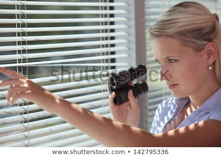 Stockfoto: A Spy Peering Through Some Blinds