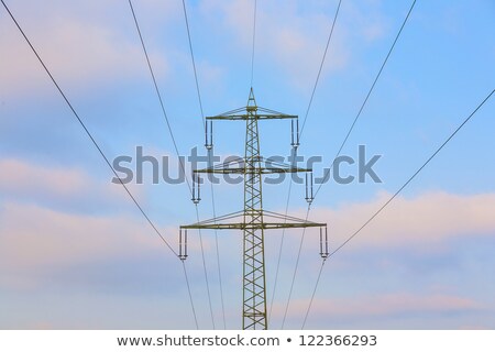 Сток-фото: Acres With Snow In Winter With Electricity Tower In Sunset