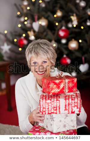 Foto stock: Beautiful Vivacious Woman With A Christmas Gift