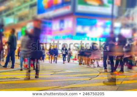 Foto stock: People Moving In Crowded Night City Street Hong Kong