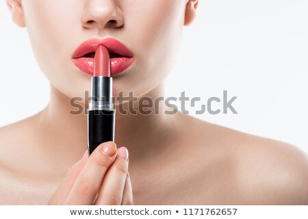 Foto d'archivio: Woman Applying Lipstick Isolated On White
