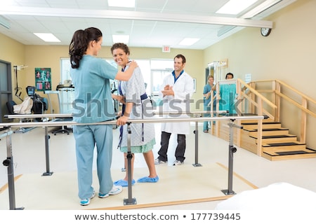 Stok fotoğraf: Patient Being Assisted By Physical Therapist While Walking