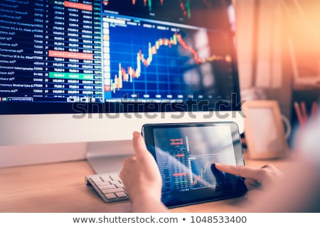 Stockfoto: Stock Exchange Trader Analyzing Graphs Chart Or Data On Multiple