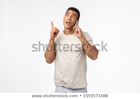 Zdjęcia stock: Guy Suggest Something While Talking Phone Handsome Masculine Young Man In T Shirt Holding Smartpho