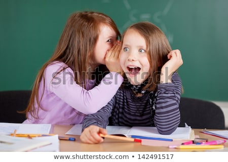 Stok fotoğraf: Two Little Girls Gossip In Classroom