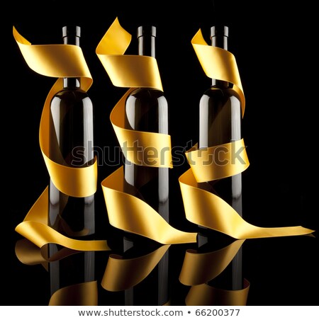 Сток-фото: Gold Ribbons Around Bottles