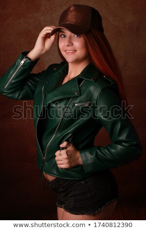 [[stock_photo]]: Elle · femme · aux · cheveux · noirs · en · veste · en · cuir · rouge