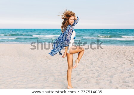 Сток-фото: Blond Woman In White Bikini Looking Over Shoulder