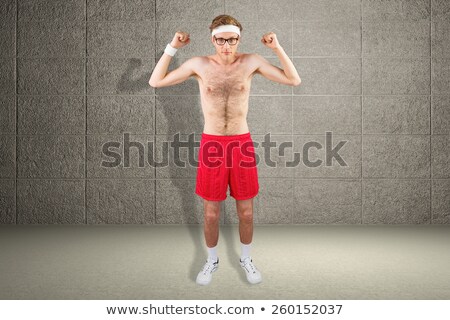 Foto stock: Geeky Shirtless Hipster Flexing Bicep
