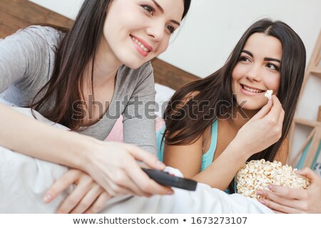 Stok fotoğraf: Close Up Of A Smiling Young Couple Watching Movie