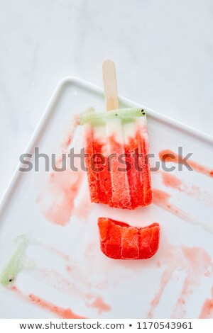 Food Pattern From Splashes And Melting Fruit Ice Cream On A Stic Stockfoto © artjazz