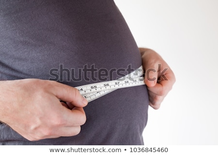 Stock fotó: Man Measuring Body Fat With Tape Measure In Dieting Concept