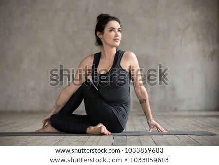 Foto stock: Woman Doing Half Spinal Twist