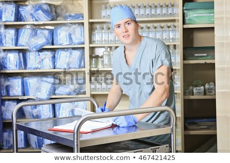 Stockfoto: Men Working On A Sterilizing Place In The Hospital He Check The Inventory